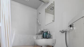 A modern bathroom with a bathtub, a toilet, and a sink.