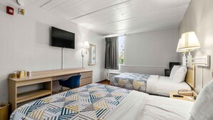 A hotel room with two beds, a desk, a chair, a TV, and a window with curtains. - 2 Queen Beds | Premium, Micfridge (Decatur GA)