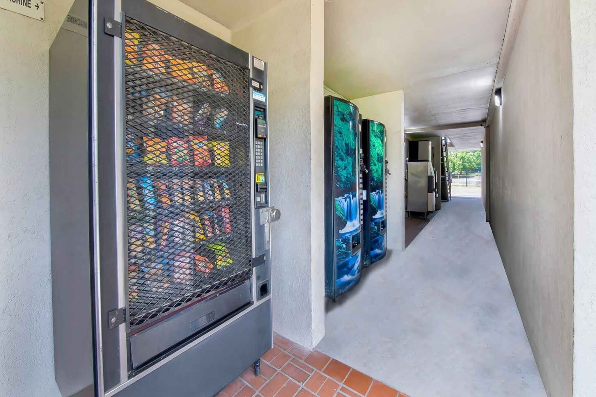 A corridor with a utility room containing electrical panels and a water cooler.