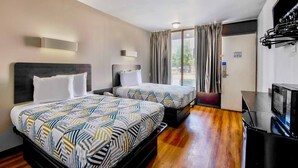 A hotel room with two beds, a TV, and a window with curtains. - 2 Full Beds|Mobility|Tub|Nsmk (Conyers GA)