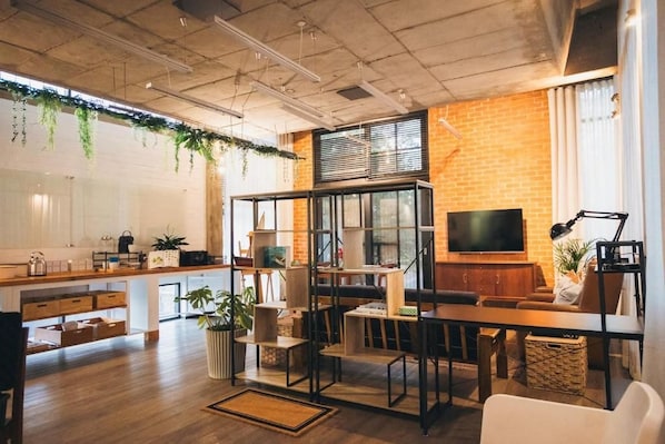 A modern interior with a kitchen, dining area, and seating space.