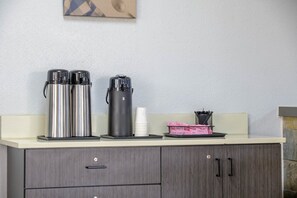 A kitchenette with stainless steel coffee makers, a white cup, and a basket with utensils. - 2 Queen Beds | Non-Smoking, Kitchen (Stockbridge GA)