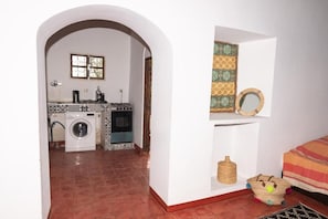 A laundry room with a washing machine, dryer, and ironing board.