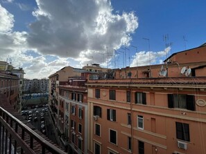 A multi-story building with balconies and satellite dishes, under a partly cloudy sky. - Luciano San Giovanni Guest House (Rome)