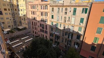 Un edificio residencial de varios pisos con balcones, antenas parabólicas y cielo despejado.