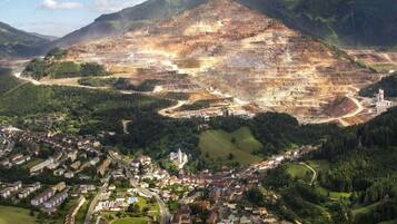 An aerial view of a town with a large open quarry and surrounding residential areas.