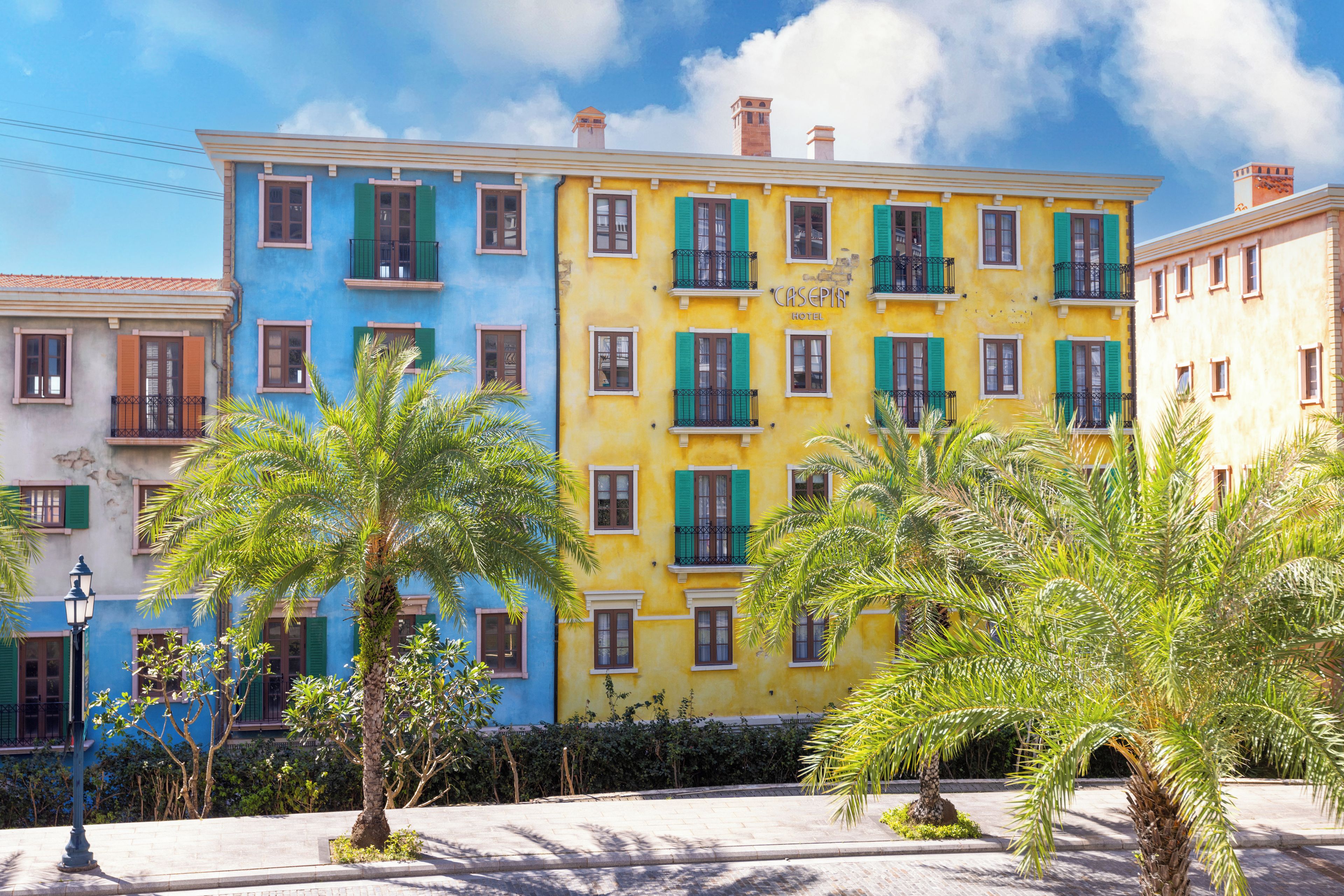 A multi-story hotel with balconies and a clear sky.