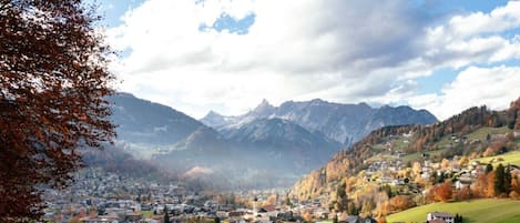 A town nestled in a valley with a mountain backdrop, featuring a mix of residential and commercial buildings.
