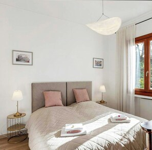 A bedroom with a bed, two bedside tables, a hanging light fixture, and two framed pictures on the wall. - Hillside villa with terraced garden near Bajardo (Bajardo)