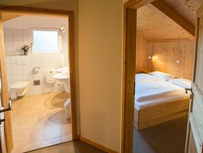 A wooden interior with a bathroom and a bed. - Cabin in Annaberg With Swimming Pool (Annaberg-Lungoetz)