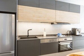 A modern kitchen with stainless steel appliances, a built-in oven, and a dishwasher. - Apartment in Rohrmoos-Untertal with sauna (Rohrmoos-Untertal)