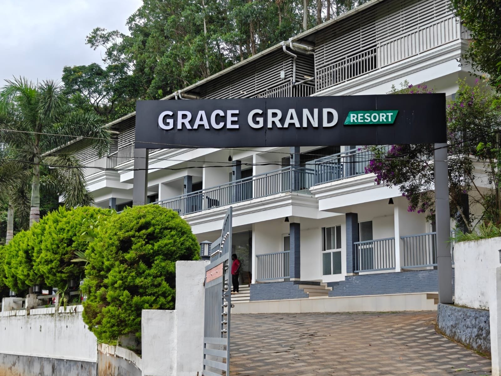 A multi-story building with a sign reading 'GRACE GRAND RESORT'.