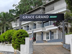 A multi-story building with a sign reading 'GRACE GRAND RESORT'. - Grace Grand Resort Munnar (Devikolam)
