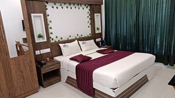 A hotel room with a bed, nightstands, a mirror, and a curtain.