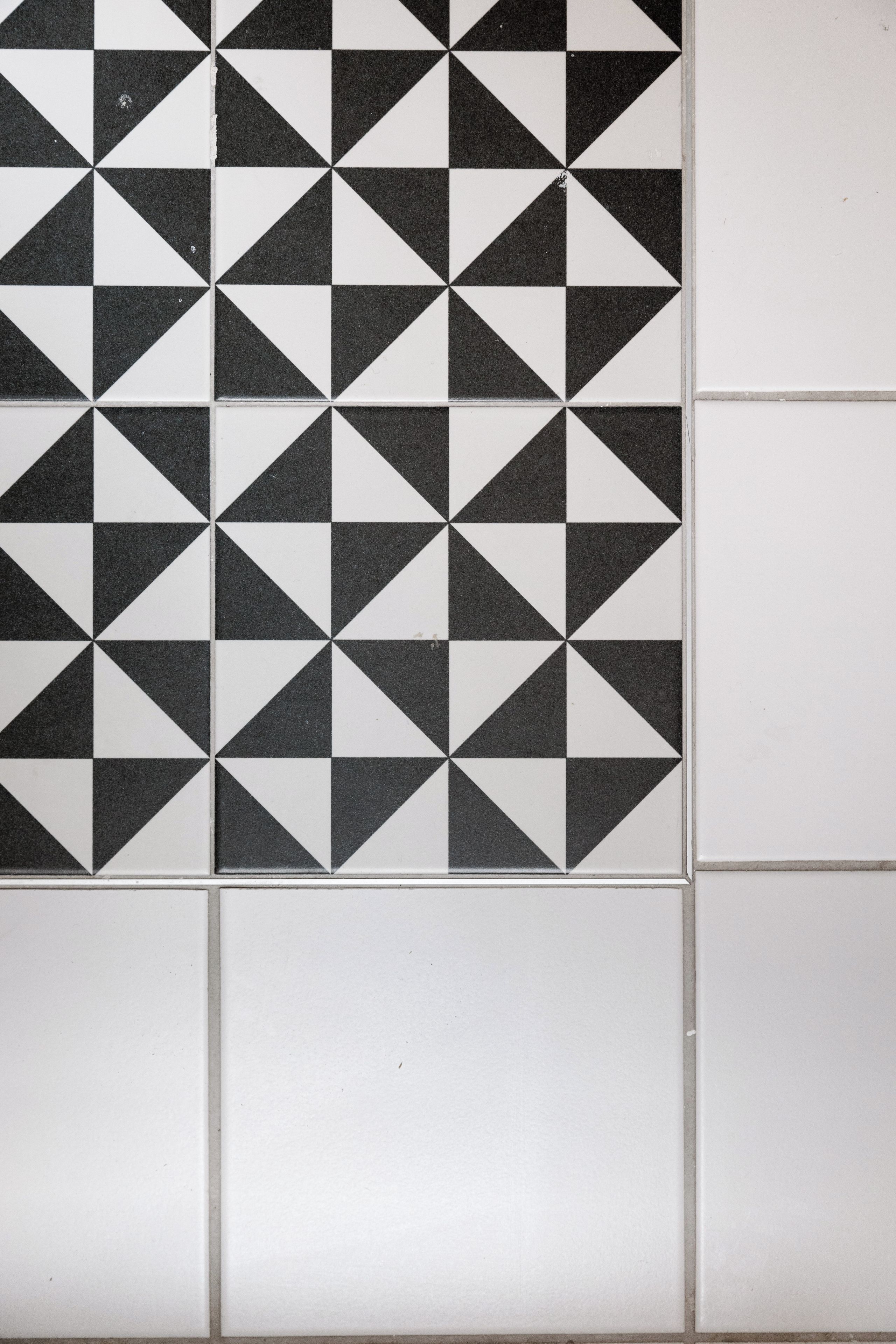 A tiled wall with a geometric pattern.