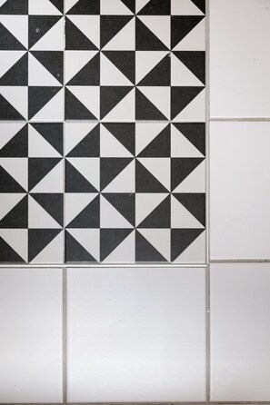 Un mur recouvert de carreaux formant un motif géométrique.
