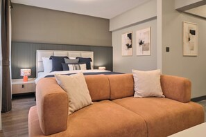 A modern bedroom with a large bed, a sofa, and artwork on the walls. - Modern, 2BR Living Areas, 2 Baths, Kadıköy (Istanbul)