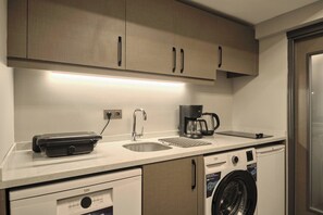 A compact kitchen with a washing machine, a coffee maker, and a dishwasher. - Modern, 2BR Living Areas, 2 Baths, Kadıköy (Istanbul)