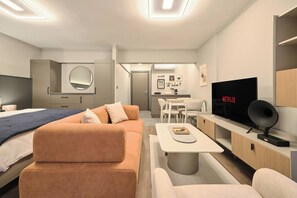 A modern living room with a sofa, a coffee table, a TV, and a dining area. - Modern 2br, Living Areas, 2 Baths, Kadıköy (Istanbul)