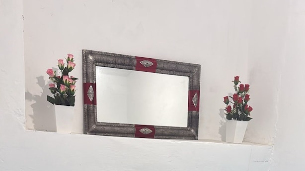 A bedroom with two beds, a dresser, a mirror, and a small shelf with flowers. - DAR LALLA KHADIJA (RABAT)