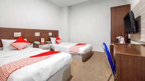 A hotel room with two beds, a desk, a television, and a minibar. - Palette La Route Residence Pattaya (Muang Pattaya)