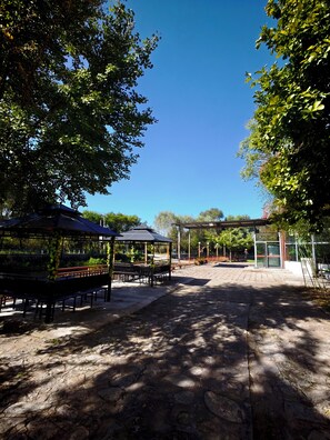 A park with a gazebo, benches, and a covered area. - Shuangyuanhui Hotel Mutianyu Great Wall (beijing)