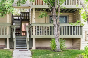 A multi-story building with a wooden deck, a staircase, and a tree in front. - Walkable Condo Near Ski Shuttle & Mammoth Creek! (Mammoth Lakes)