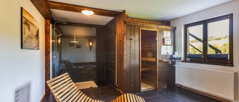 A modern bathroom with a shower, a wooden bench, and a potted plant.