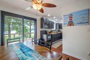 A modern kitchen with dark cabinetry, a microwave, and a stove.
