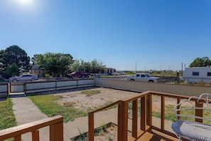 A fenced outdoor area with a wooden deck, a bench, and a clear sky. - Fort Stockton Home, Your Big Bend Basecamp (Fort Stockton)