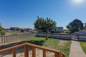 A residential area with a fenced yard, a wooden deck, and a clear sky. - Fort Stockton Home, Your Big Bend Basecamp (Fort Stockton)