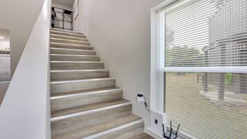 A staircase with a modern design, leading to an upper level.