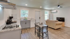 A compact kitchen with a dining area, a built-in oven, and a ceiling fan. - Boating & Fishing Base! Studio Near Point A Lake (Red Level)