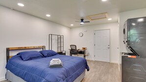 A bedroom with a bed, a desk, a chair, a wardrobe, and a ceiling fan. - Boating & Fishing Base! Studio Near Point A Lake (Red Level)