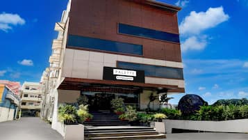 A multi-story building with a sign reading 'PALETTE' and 'Company-Serviced.'