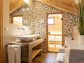 A wooden bathroom with two sinks, a mirror, and a shower area. - Cabin in Annaberg With Swimming Pool (Annaberg-Lungoetz)