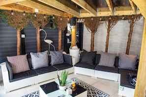 A modern living room with a sofa set, a coffee table, and decorative plants.
