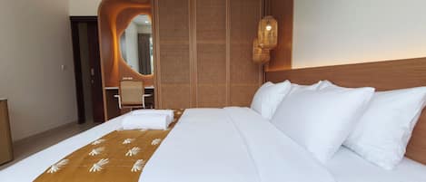 A hotel room with a large bed, a wooden headboard, a wall-mounted air conditioner, and a woven partition.