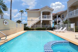 A swimming pool with a tiled edge, a lifebuoy, and a no swimming sign. - Fabulous Bayside Condo from Rent On Padre (South Padre Island)