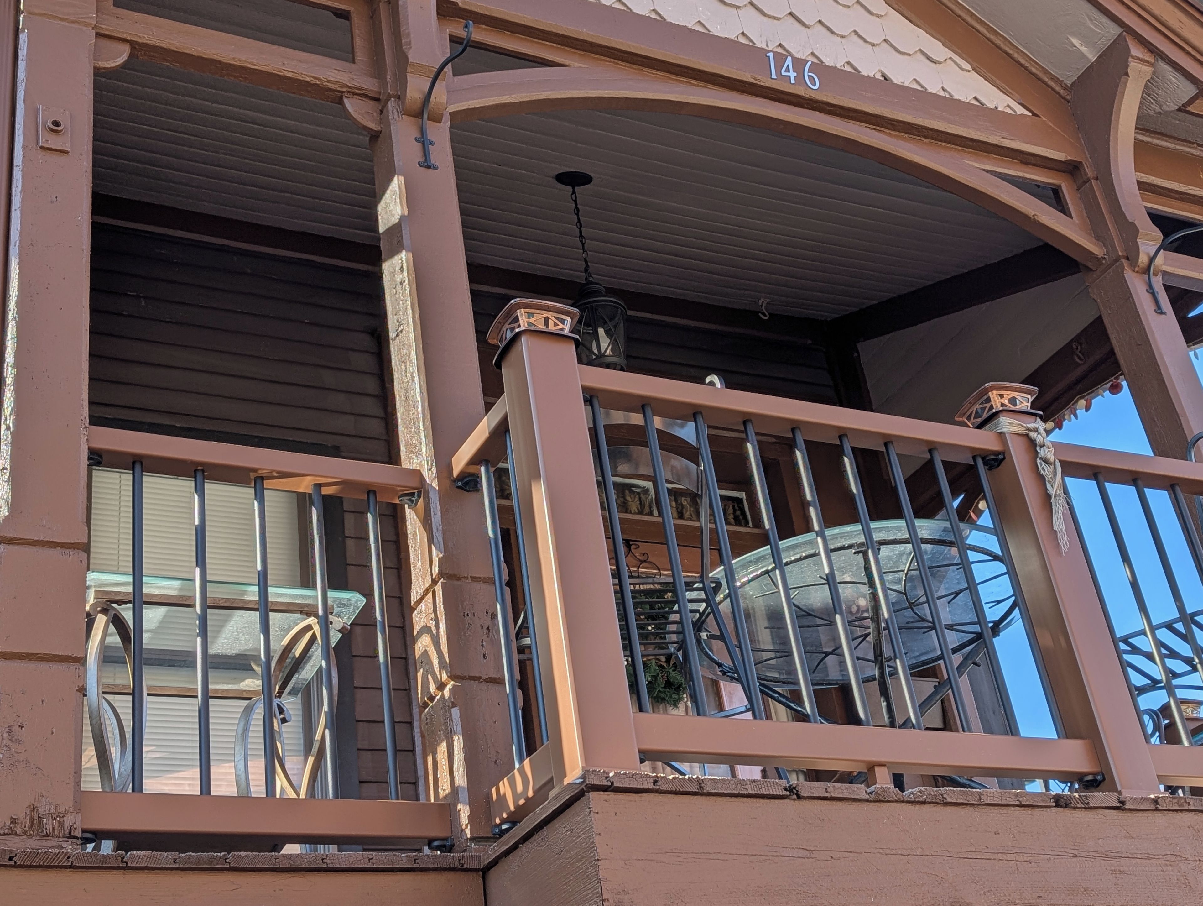A balcony with metal railings and a number '146' on the wall.