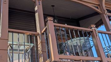 A balcony with metal railings and a number '146' on the wall.