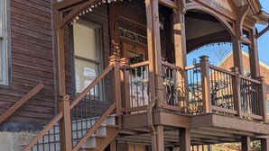 A two-story house with a balcony, a staircase, and a porch. - 146-7 AA. Gorgeous 2-bedroom apartment with AC in New London (New London)