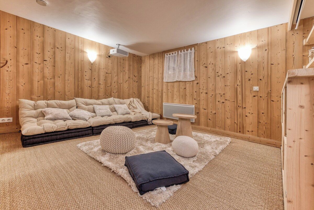 A cozy room with a sectional sofa, a small coffee table, and a rug.