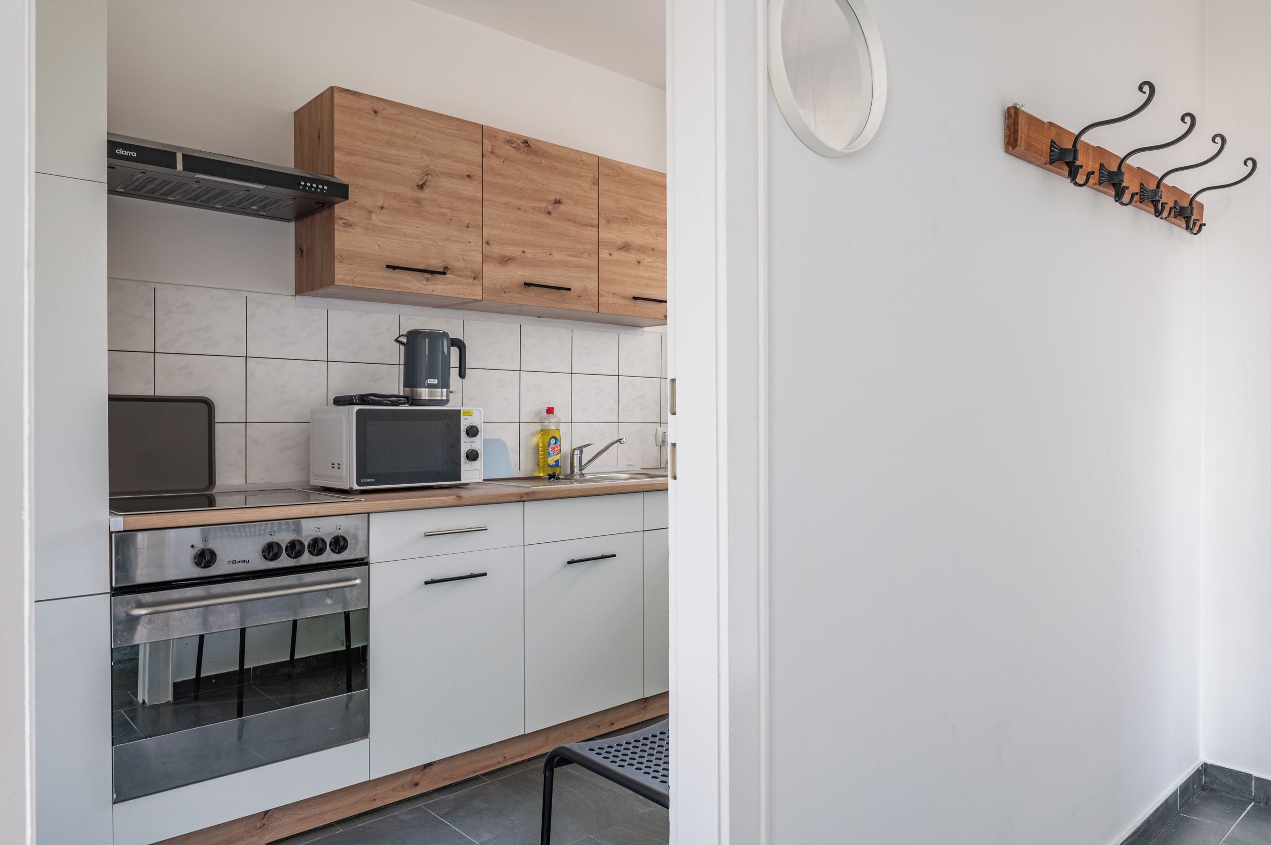 A modern kitchen with a built-in oven, a coffee maker, and a toaster.
