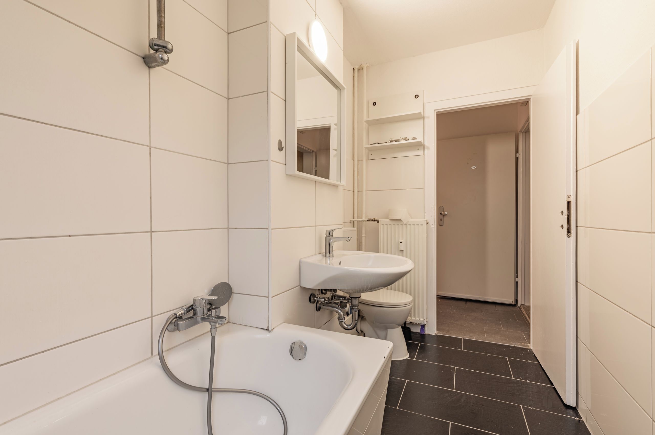 A bathroom with a bathtub, a sink, and a toilet.