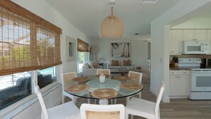 A modern kitchen with white cabinets, a microwave, and a stove. - Beautiful 3-bedroom, 2-bathroom waterfront home sits right on the canal! 1131 Fern Court (Marco Island)