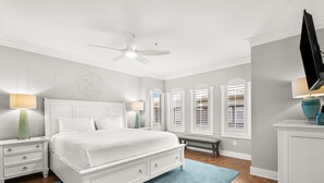 A bedroom with a bed, nightstands, a bench, a dresser, and a ceiling fan. - 3BR Seagrove Beach Pet-Friendly Penthouse | Private Beach & Pool (Santa Rosa Beach)