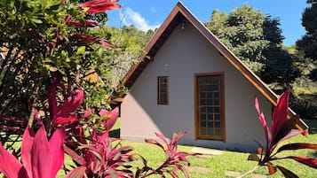 A house with a triangular roof, a wooden door, and a window.