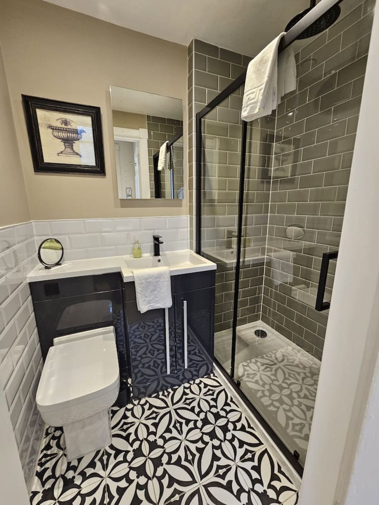 A bathroom with a shower, sink, and toilet.