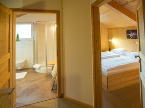 A wooden interior with a bathroom and a bedroom. - Cabin in Annaberg With Swimming Pool (Annaberg-Lungoetz)